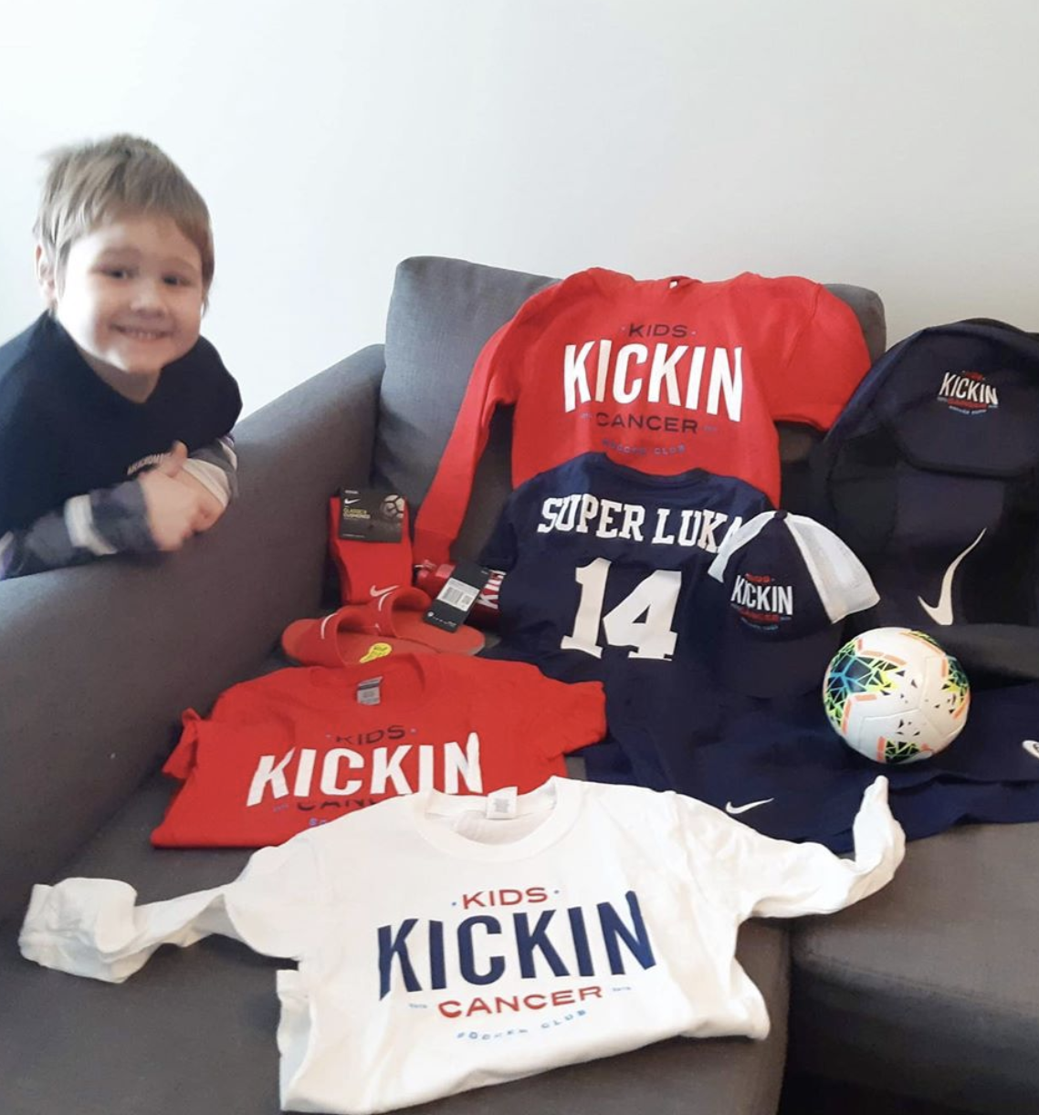 cancer kickers teammate luka with cancer kickers gear nike label player kit laid out on sofa